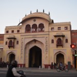 Esam atpakaļ Džaipūrā, reku Tripolia vārti. Lai kā es gribēju, ka tie, līdzīgi kā Deli un Lahorā, nosaukti par godu virzienam, uz kuru ved, bet tā nemaz nav. Laikam Tripole ir pārāk tālu no šejienes, lai kāds vispār iedomātos uz turieni doties. Patiesībā nosaukums apzīmē eju skaitu - pa šiem vārtiem var nokļūt trīs vietās - uz vecpilsētu (pilsētas daļu, kas vēsturiski bijusi iekšpus mūra), uz karalisko pili un uz ielas. Pa šiem vārtiem pat mūsdienās drīkst iet tikai visādi karaļi un citi oficiālu ceremoniju pārstāvji, tāpēc mums jāmet lielais līkums apkārt.